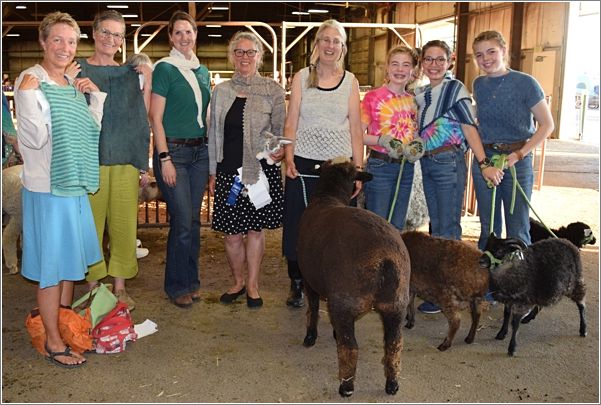 Spinners Lead participants Louise, Sarah, Laurel, Lucelle, Daphne, Ella, Marissa and Anna model their projects from, This Started with Violet, just before the event. Photo: Peggy Lundquist.